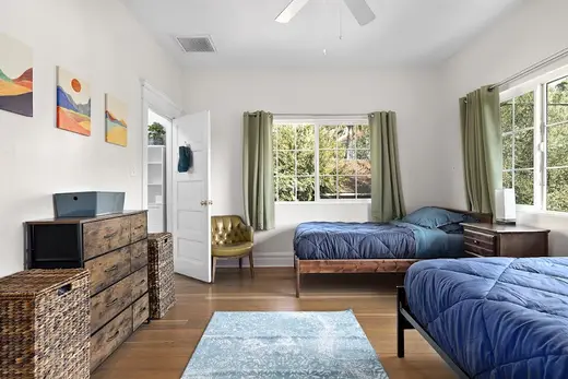 Cozy bedroom with two beds at Hilltop House Sober Living, a sober living home in Los Angeles.
