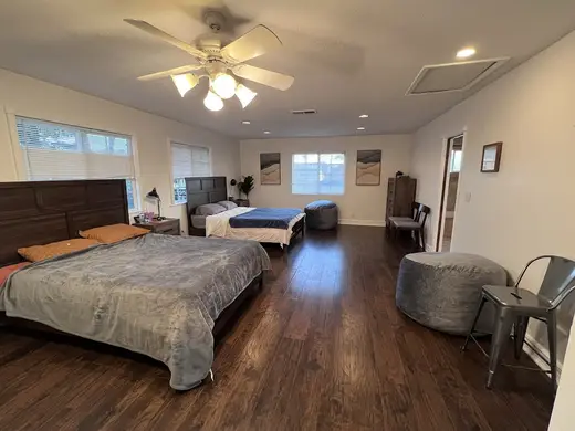 Spacious bedroom with two beds at House of Zen, a sober living home in Los Angeles.